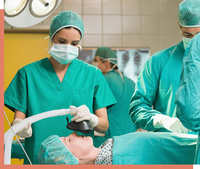 A group of doctors in green scrubs and masks.